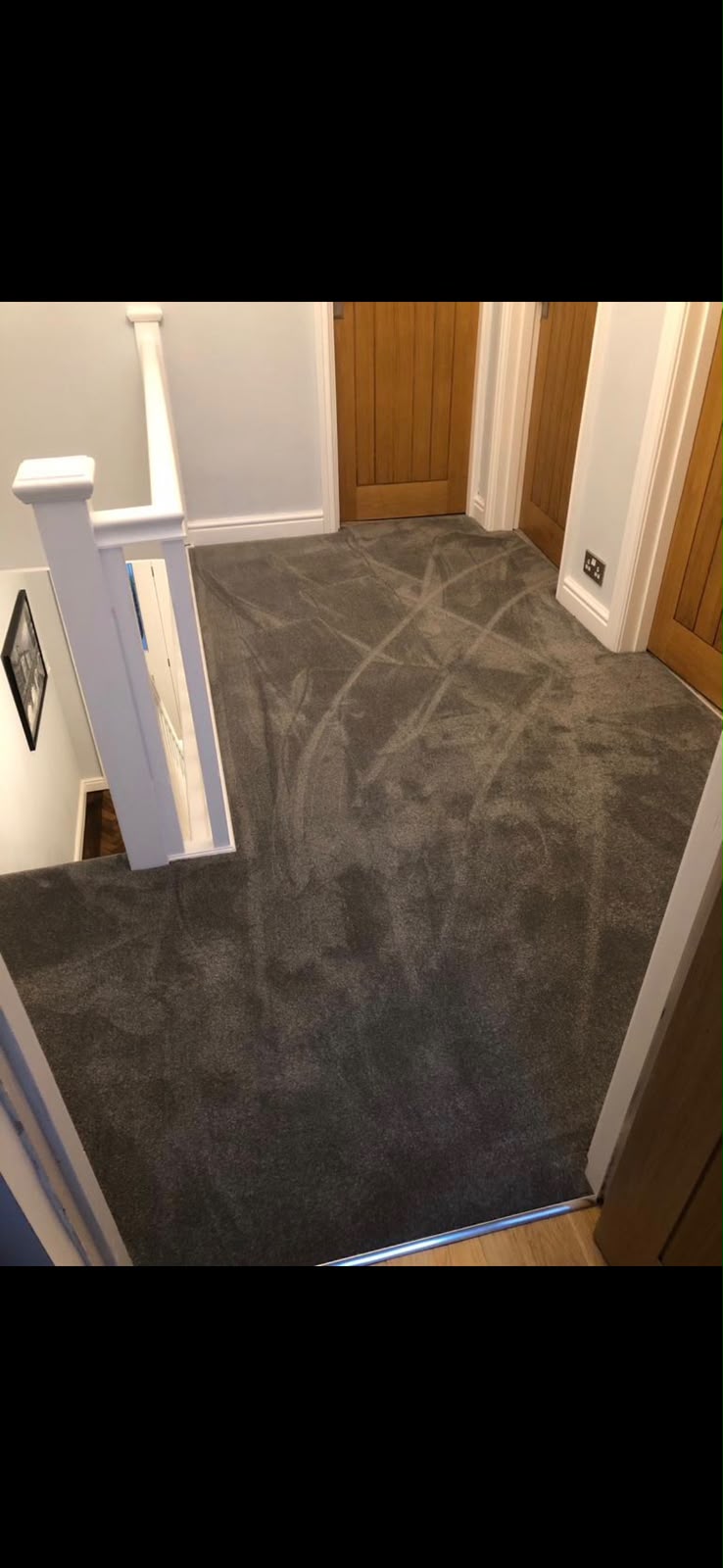 Grey carpet fitted on a landing and staircase