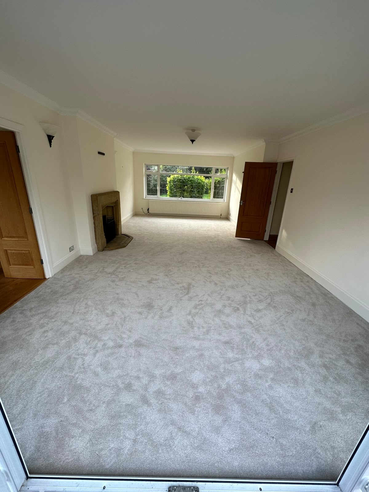 Grey carpet fitted throughout a through-lounge