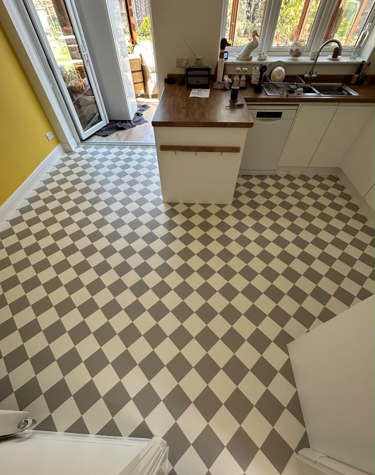 Checkerboard vinyl flooring fitted in a kitchen