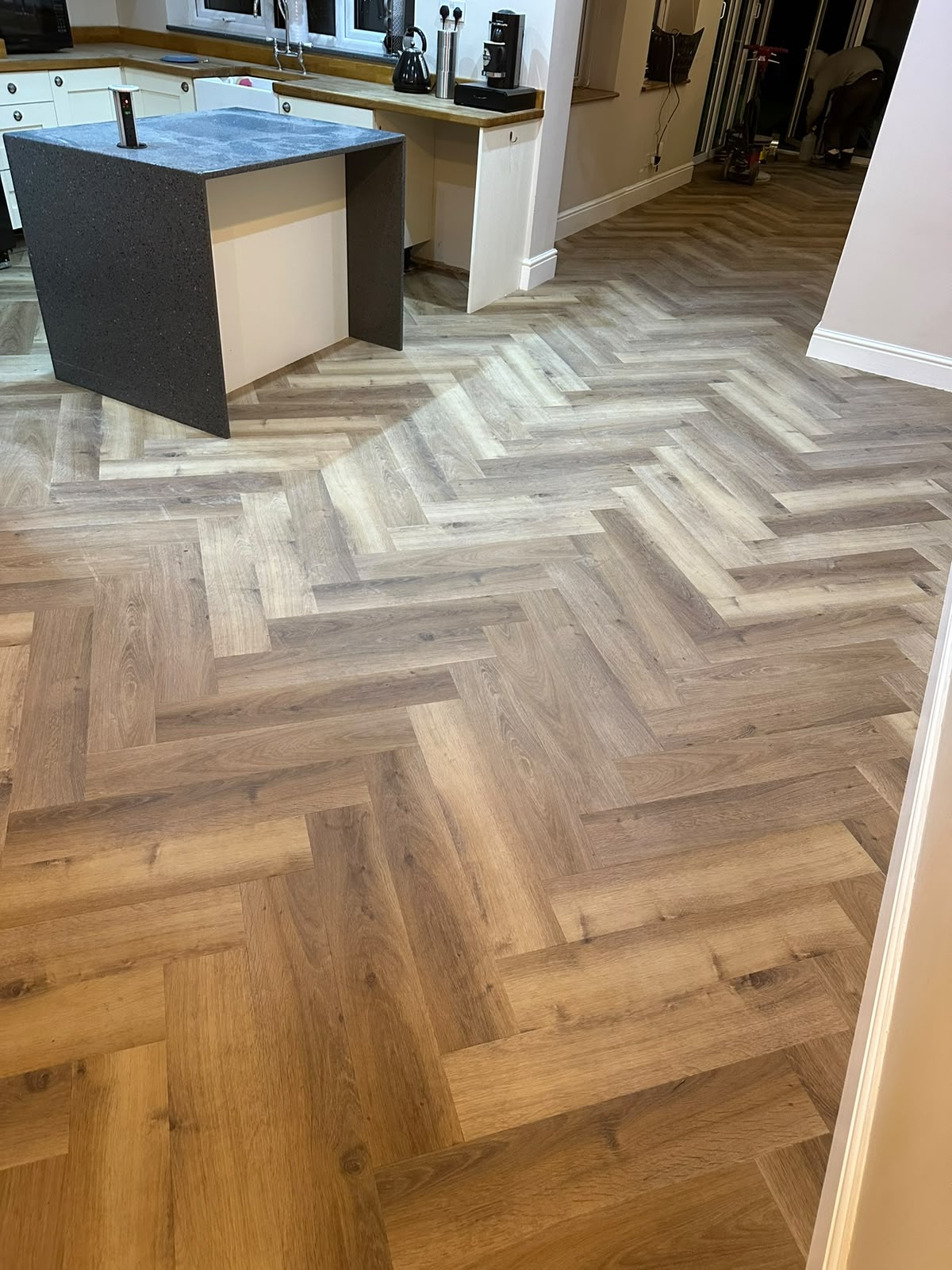 Whitewashed herringbone LVT flooring