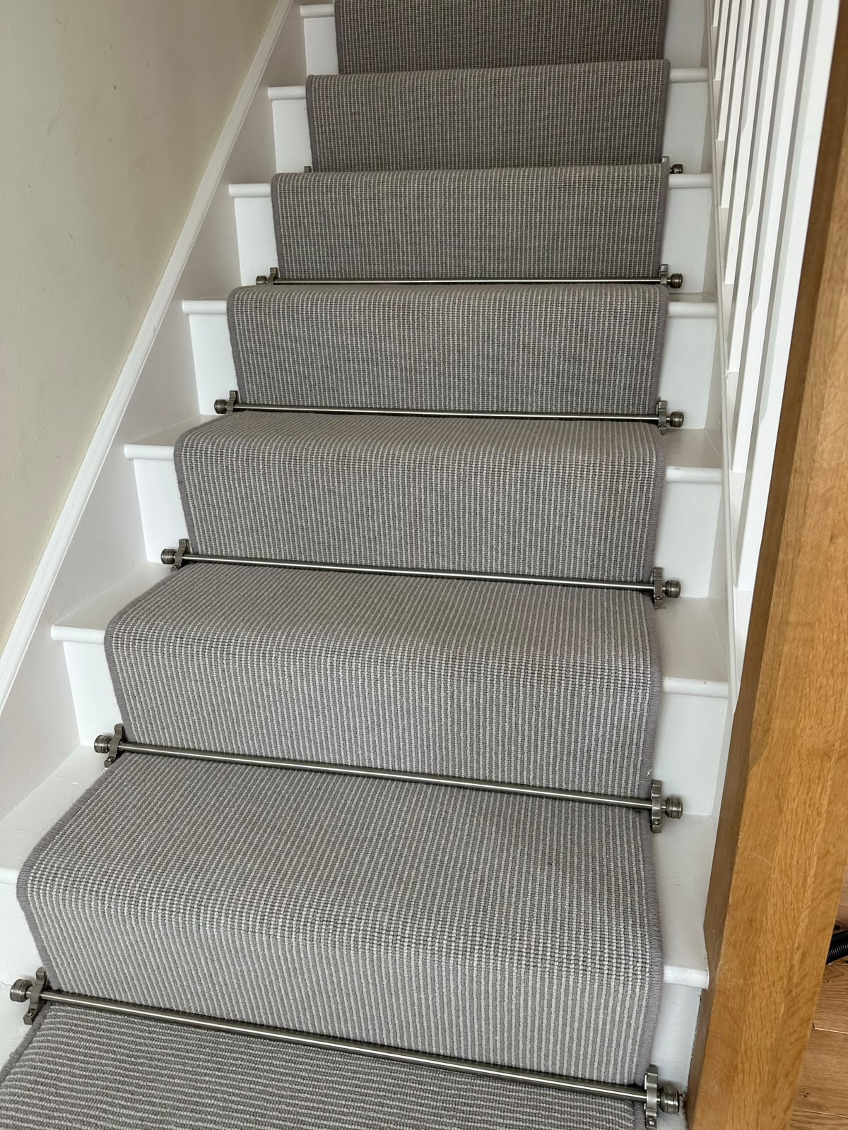 Striped stair runner fitted with brushed chrome stair rods