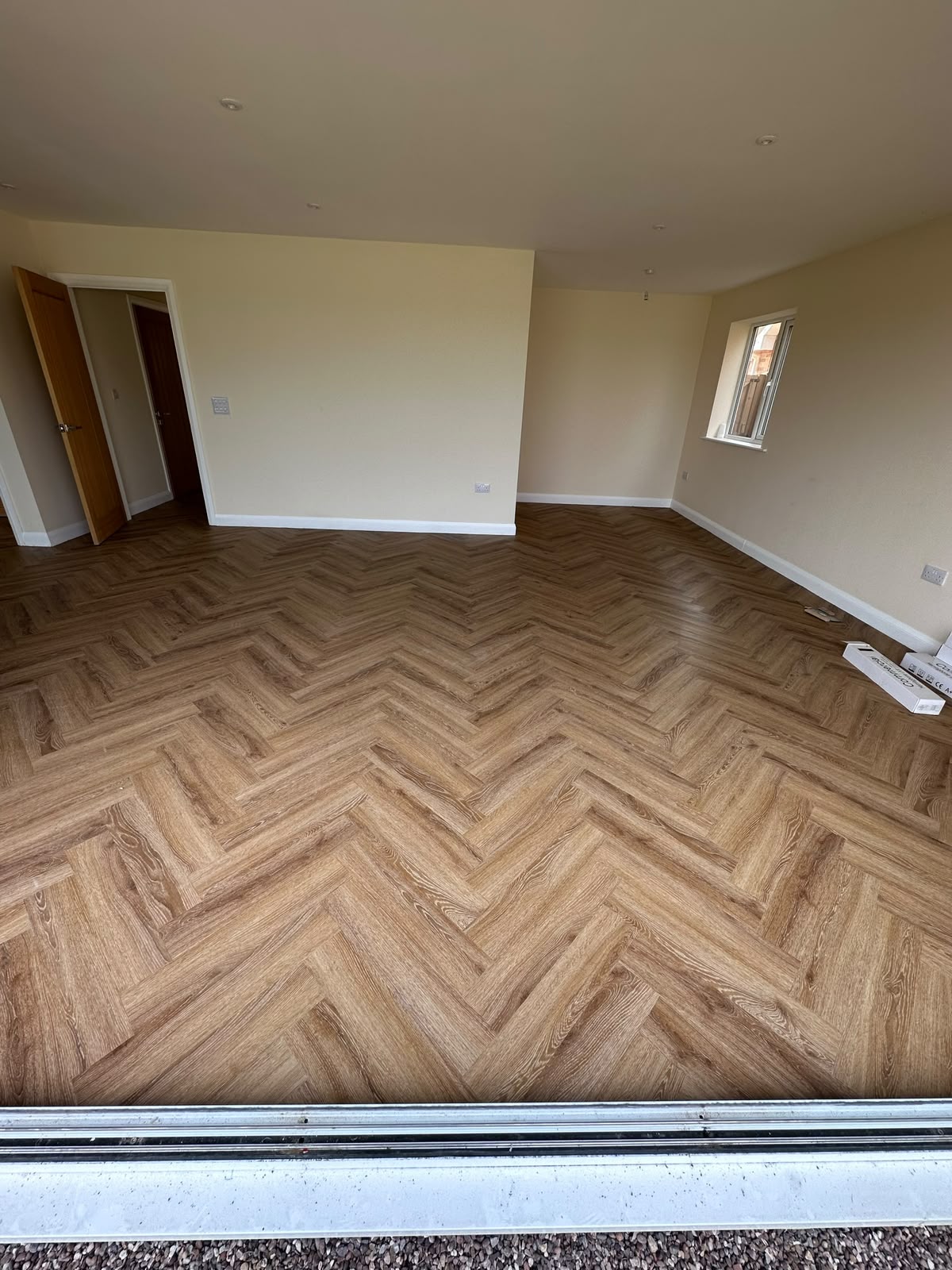 Walnut-tone herringbone LVT in a lounge